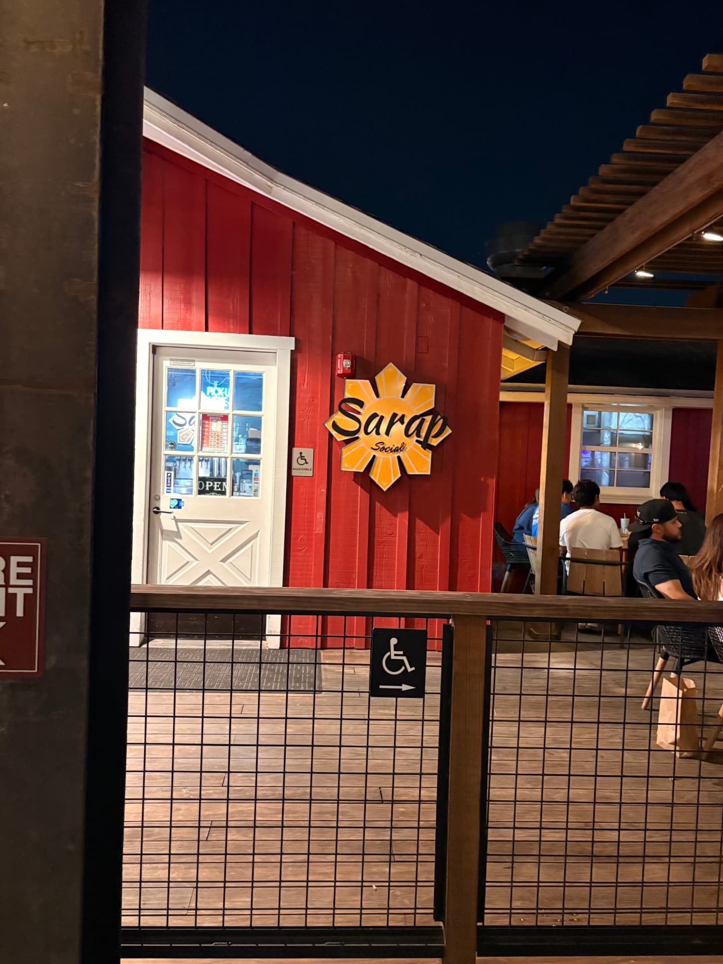 Guests gathering beside the Sarap Social sign at Farm House Collective